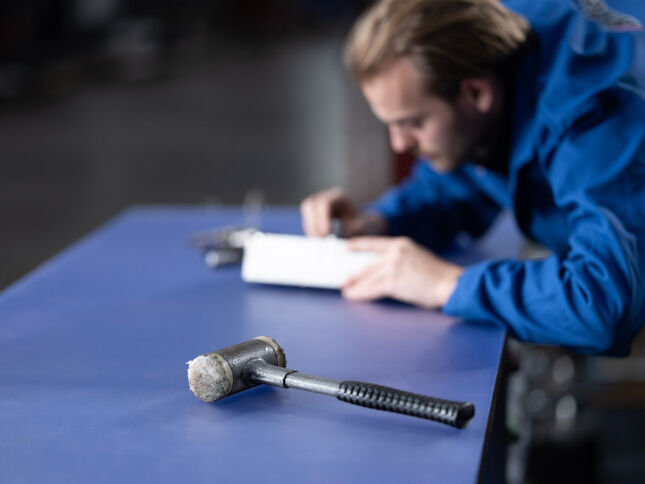 workbench with frosted cutting mat and hammer